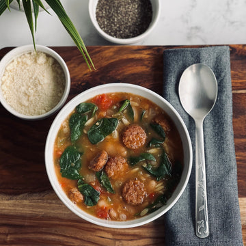 Greens, Beans, and Orzo Soup: Simple, rustic, hearty soup is full of flavor, and is a great easy meal to make. Herby plant based Italian meatballs, creamy white beans, orzo and healthy greens cooked in savory tomato broth is absolutely perfect any day. 