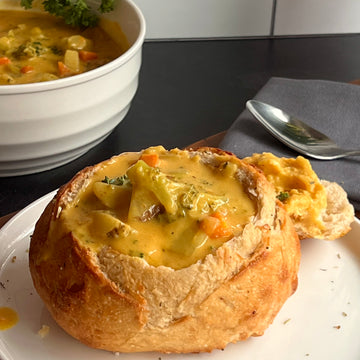 Boccoli cheddar soup; Cheesy soup with broccoli, carrots, diced potatoes served in a warm bread bowl. Absolutely delicious. This meal kit its easy to make and plant-based. 